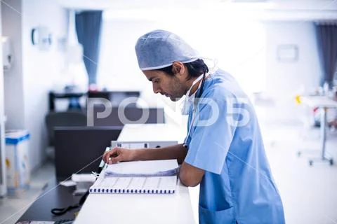 Surgeon reading medical reports Stock Photos