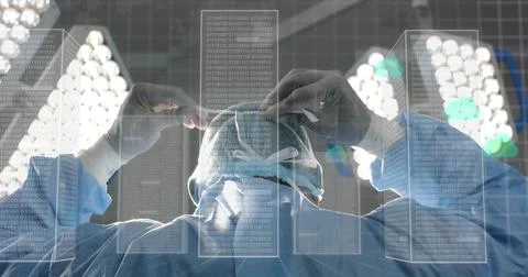 Surgeon securing surgical cap under LED lights in operating theater, with binary 写真素材