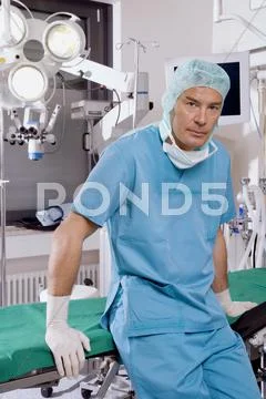 Surgeon sitting on operating table Stock Photos