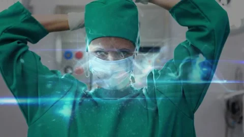 Surgeon starting sterile prep, adjusting neckline, fitting mask and cap while Video stock 317185201