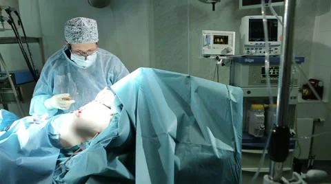 Surgeon stitching up in operating room Video stock 58123475