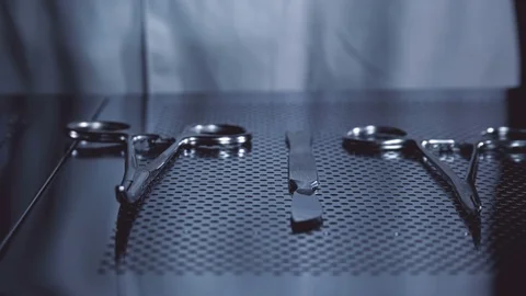 The surgeon takes a scalpel from the table with the tools for the operation Stock Footage 81007253