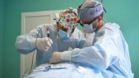 Surgeon team cooperating during operation.  Stock Footage 174051094