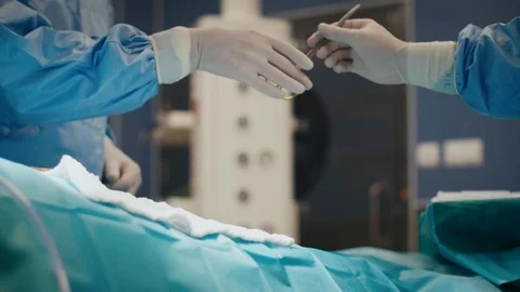 Surgeon using medical scissors during an operation Stock-Footage 105350586