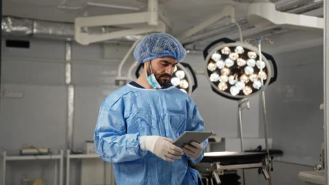 Surgeon Using Tablet In Operating Room Stock Footage 315967799