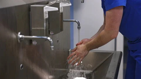 Surgeon washing hands carefully preparing for operation. Stock Footage 229686923