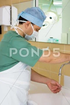 Surgeon washing his hands in operating room Stock Photos