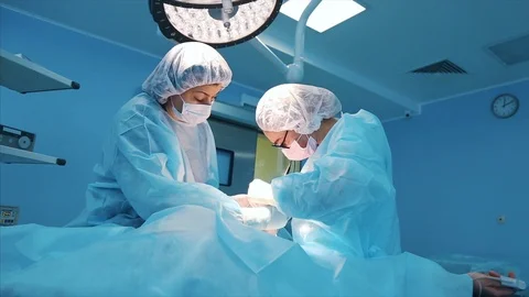 Surgeon at work. a team of professional surgeons performs surgery on the patient Stock Footage 104647514