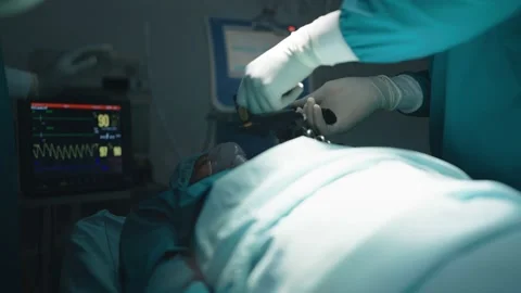 Surgeons and nurses help intensive care patient Stock Footage 197779704