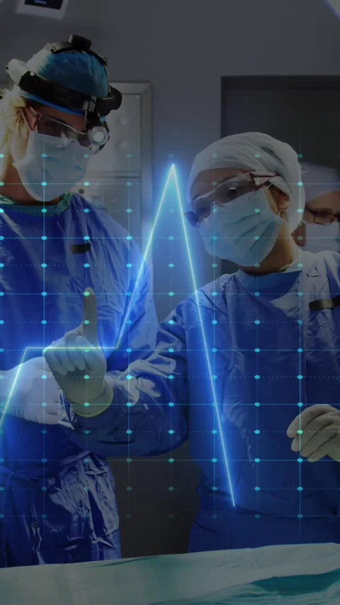 The surgeons are interacting with each other and the cardiograph is over a black Stock Footage 321324010