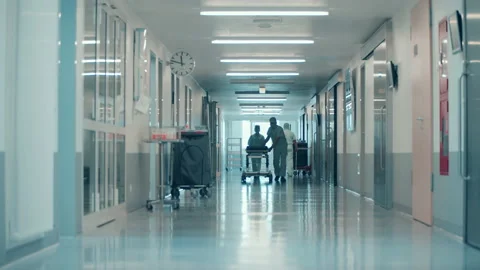 Surgeons are rolling a bed along the hospital hallway Stock Footage 164858470