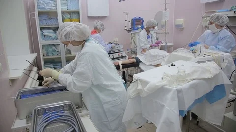The surgeon's assistant pushes the endoscopic equipment into the container after Video stock 79267988
