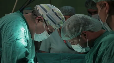 Surgeons close up. Surgical team performing operation in the hospital room. Stock Footage