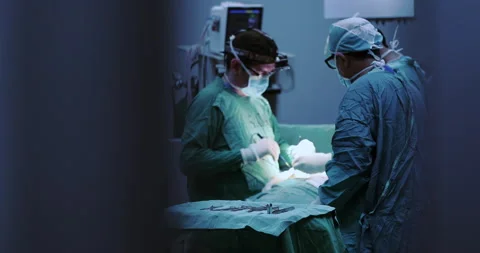Surgeons collaboration operating through hospital operation room door Stock Footage 146129752