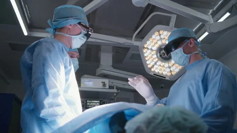 Surgeons discuss process of operating patient Stock Footage 252110172