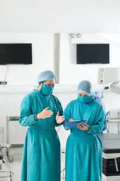 Surgeons discussing document Stock Photos