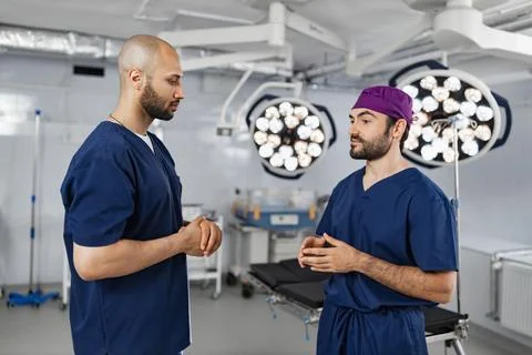 Surgeons Discussing in Operating Room Stock Photos