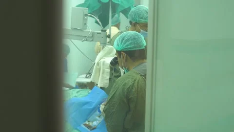 Surgeons Doing Cataract Surgery Using High-Precision Microscope Stock Footage 295175182
