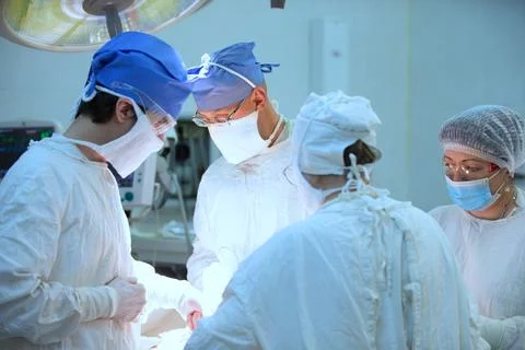 Surgeons during the operation. Professional doctors performing surgeries. Stock Photos