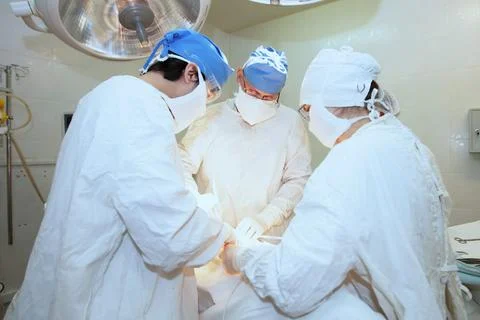 Surgeons during the operation. Professional doctors performing surgeries. Stock Photos