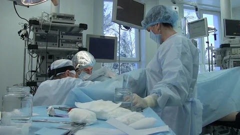Surgeons during surgery. perform out an operation. nurse, table instruments Stock Footage 125816805