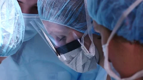 Surgeon's faces in the masks, Closeup, 4k footage Stock Footage 55961977