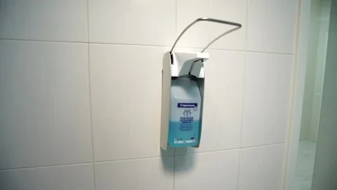  surgeon's hand-handling device hangs in a hospital sanitizer Stock-Footage 130649486