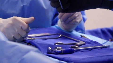 Surgeons hands choosing chirurgical material for surgery Stock Footage 45825174