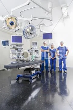 Surgeons in hospital operating room Stock Photos