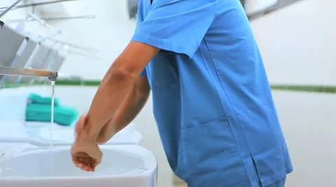 Surgeons in a hospital washing hands Stock Footage