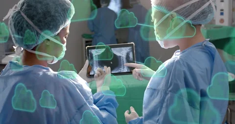 Surgeons hovering hand over tablet initiating health cloud sync of spinal scan Video stock 314734618