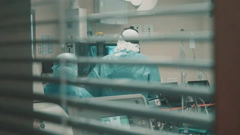 Surgeons looking at bones scans are filmed through the blinds Stock Footage 166574908