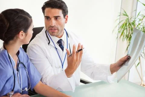 Surgeons looking at a set of X-ray Stock Photos