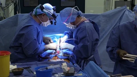 Surgeons operating in hospital Stock Footage 85929707