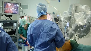 Surgeons operating with medical robot Stock Footage 85894155