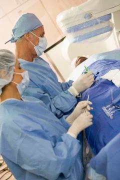 Surgeons Operating On Patient Stock Photos