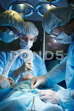 Surgeons Operating On A Patient
