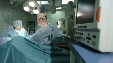 Surgeons in operating room durin operation. Cardio Monitor Stock-Footage 58123468