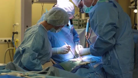 Surgeons in the operating room with a patient Stock Footage