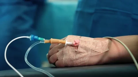 Surgeons in the operating room perform an operation on a patient. A complex Stock Footage 219427297