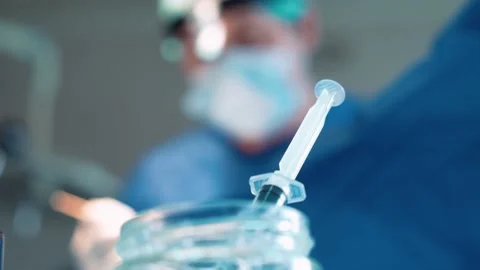 Surgeons in the operating room perform an operation on a patient. A complex Stock Footage 220523932