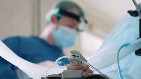 Surgeons in the operating room perform an operation on a patient. A complex Stock Footage 228884016