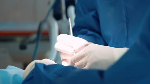 Surgeons in the operating room perform plastic surgery on a patient. Complex Stock Footage 220523908