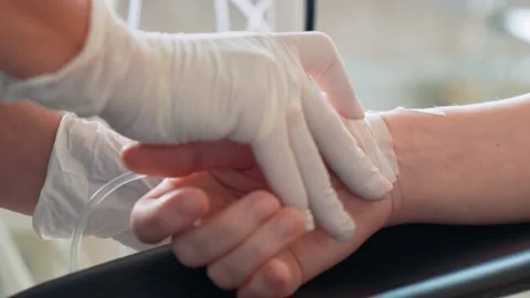 Surgeons in the operating room prepare the patient for surgery. A close-up of Stock Footage 220521883