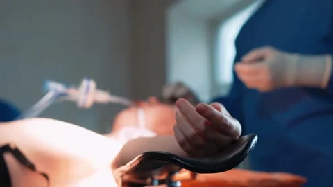 Surgeons in the operating room prepare the patient for plastic surgery. A close Stock Footage 220521951