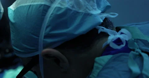 Surgeons Operating Together with real operation footage Stock Footage 146698717