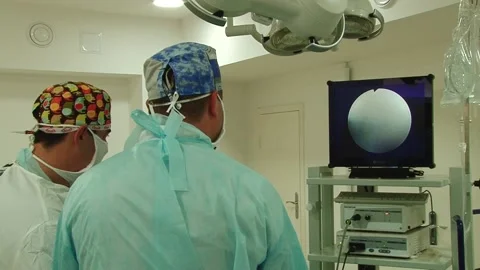 Surgeons perform knee surgery Stock Footage 130793913