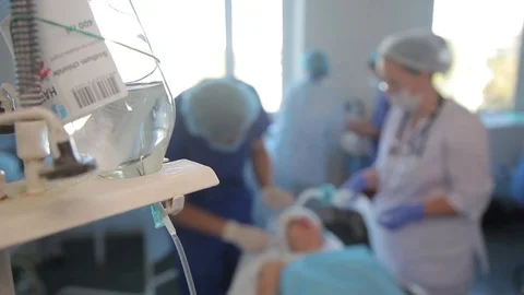 Surgeons perform an operation. near the operating table. dropper Stock-Footage 99194734