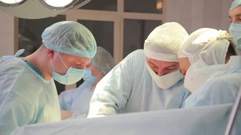 Surgeons perform an operation. near the operating table. Stock Footage 135310044