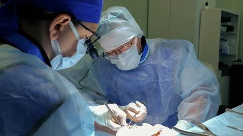 Surgeons performing delicate open abdominal operation in modern operating room 库存照片